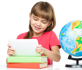 Image showing Young girl is using tablet