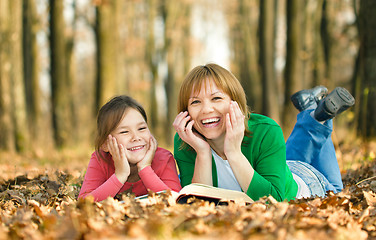 Image showing Mother is reading book with her daughter