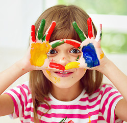 Image showing Portrait of a cute girl playing with paints