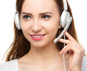 Image showing Lovely young woman is talking to customers