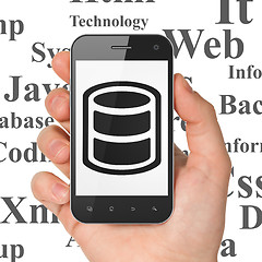 Image showing Programming concept: Hand Holding Smartphone with Database on display