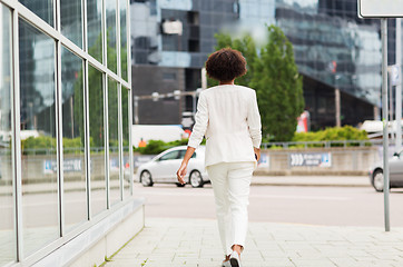 Image showing african american businesswoman walking in city