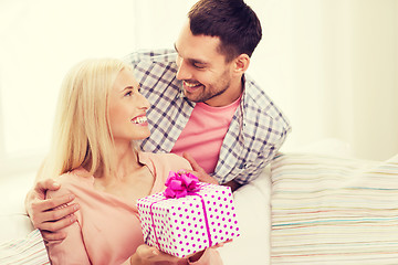 Image showing happy man giving woman gift box at home