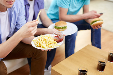 Image showing close up of friends eating fast food at home