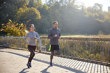 Image showing happy couple running outdoors