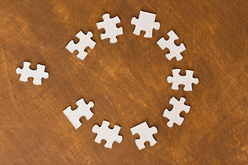 Image showing close up of puzzle pieces on wooden surface