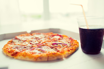 Image showing close up of pizza with cola on table