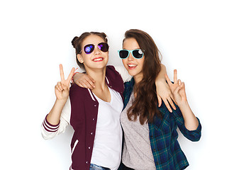 Image showing smiling teenage girls in sunglasses showing peace