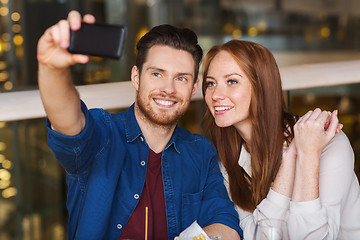 Image showing couple taking selfie by smartphone at restaurant