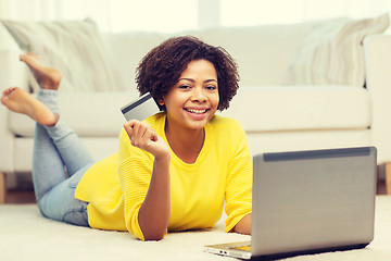 Image showing happy african woman with laptop and credit card