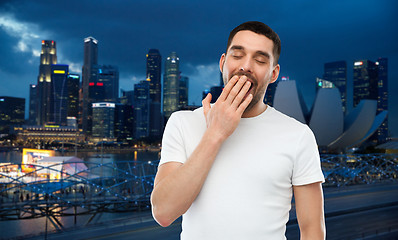 Image showing yawning man over gray background