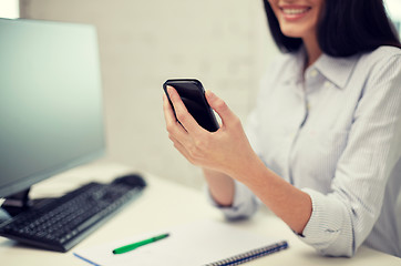 Image showing close up of woman texting on smartphone at office