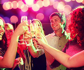 Image showing smiling friends with glasses of champagne in club