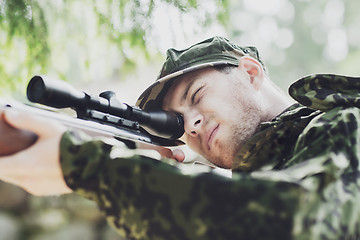 Image showing young soldier or hunter with gun in forest