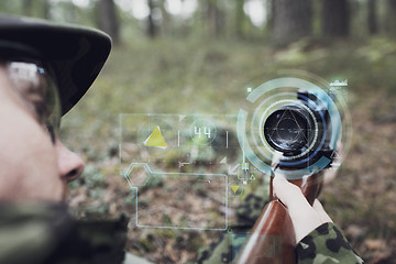 Image showing close up of soldier or sniper with gun in forest