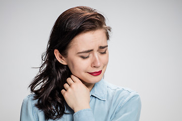 Image showing The portrait of a crying young lonely woman on gray