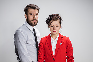 Image showing The business man and woman conflicting on a gray background