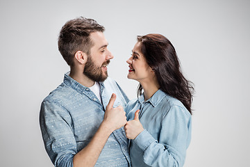 Image showing Two young smiling people with thumbs-up gesture