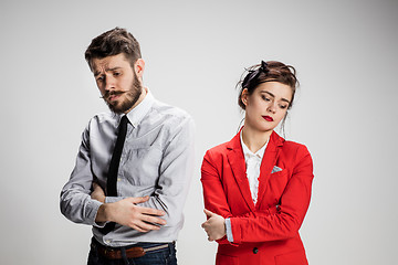 Image showing The sad business man and woman conflicting on a gray background