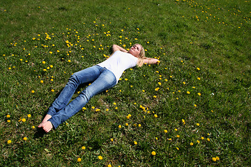 Image showing Woman lying on grass