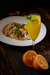 Image showing Orange cocktail on rustic wooden table