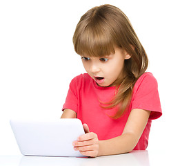 Image showing Young girl is using tablet