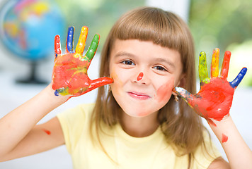 Image showing Portrait of a cute girl playing with paints