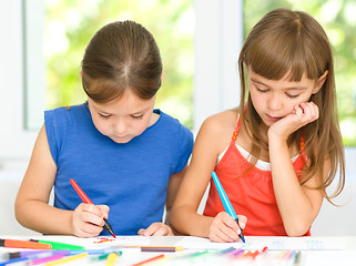 Image showing Little girls are drawing using pencils