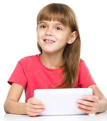 Image showing Young girl is using tablet