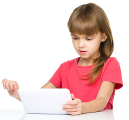 Image showing Young girl is using tablet