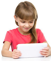 Image showing Young girl is using tablet