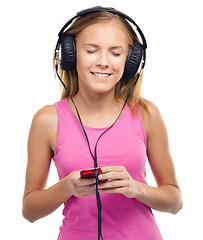 Image showing Teen girl enjoying music using headphones