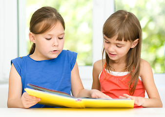 Image showing Little girls are reading book