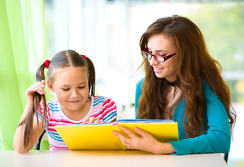 Image showing Mother is reading book with her daughter