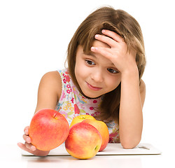 Image showing Little girl with red apples