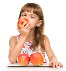 Image showing Little girl with red apples