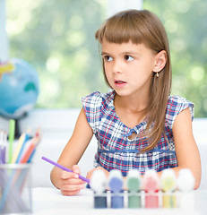 Image showing Little girl is painting with gouache