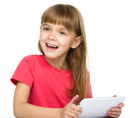 Image showing Young girl is using tablet