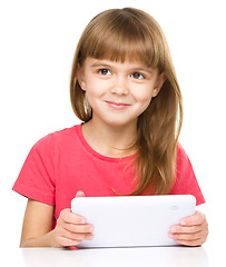 Image showing Young girl is using tablet