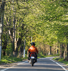 Image showing Riding a scooter