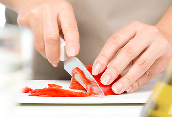 Image showing Cook is chopping bell pepper