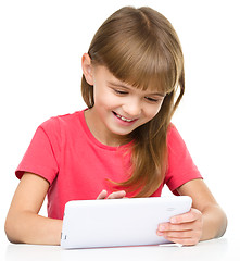 Image showing Young cheerful girl is using tablet