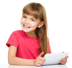 Image showing Young girl is using tablet