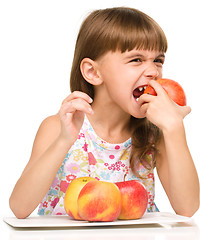 Image showing Little girl with red apples