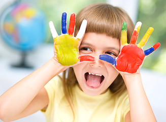 Image showing Portrait of a cute girl playing with paints