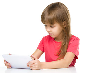 Image showing Young girl is using tablet