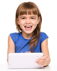 Image showing Young girl is using tablet