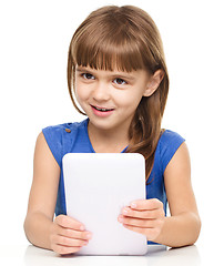 Image showing Young cheerful girl is using tablet