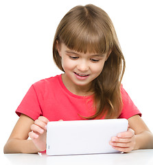 Image showing Young girl is using tablet