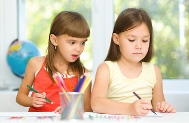 Image showing Little girls are drawing using pencils